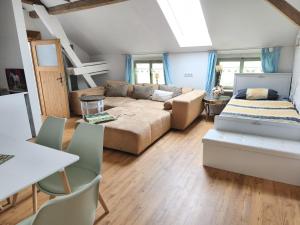 a living room with a couch and a table at Ferienhaus Siegstrand mit Flusszugang in Mittelhof