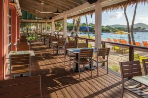 a restaurant with tables and chairs on the beach at Margaritaville Vacation Club - St Thomas in Frydendal