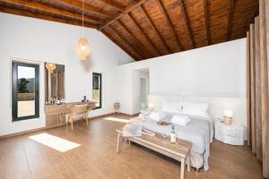 a bedroom with a bed and a table at Villa Hill View Ena in Chourdátika +17 photos