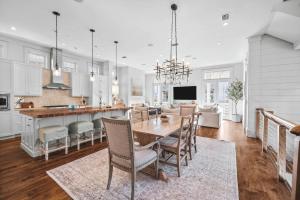 a kitchen and dining room with a table and chairs at Sadie's Cottage in Rosemary Beach
