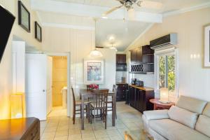 a kitchen and living room with a couch and a table at Kokomo Premium King - King Cottage in Turtle Cove