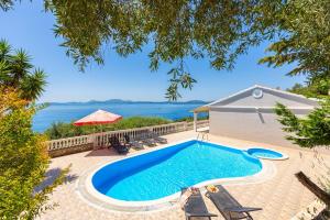 a pool with a view of the water at Villa Theodora in Nisaki