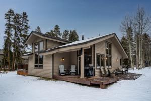 a small house with a deck in the snow at Lazy Bear in Breckenridge