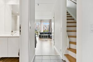 a hallway leading to a living room with white walls at Modern Townhouse With Private Outdoor Area - 2BR 4 Beds in Copenhagen