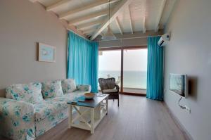 a living room with a couch and a table at Kabakum Holiday Houses in Golden Sands