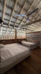 a bedroom with two beds and a ceiling fan at Rincón del Mangle in San Onofre