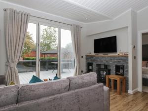 a living room with a couch and a fireplace at 7 Lake View in Troutbeck Bridge