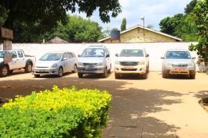 a group of cars parked in a parking lot at WELLSPRINGS HOLDINGS AND HOTELS Ltd in Nalakonge