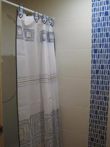 a shower curtain is hanging in a bathroom at Habitación independiente en Casa Rural Javier in Valmuel