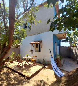 a patio with a table and chairs in front of a house at Mar de Arraial, Suites da Ju in Arraial do Cabo +33 photos