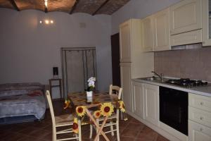 a kitchen with a table with sunflowers on it at B&B Guado di Pio- monolocale in Il Guasto
