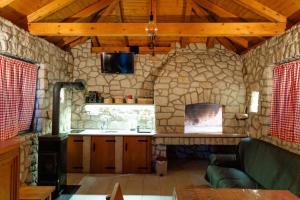 a kitchen with a stone fireplace in a room at Guesthouse Papac Apartments in Stolac