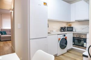 a kitchen with a refrigerator and a dishwasher at Black Sand Cozy Apartment in Livramento