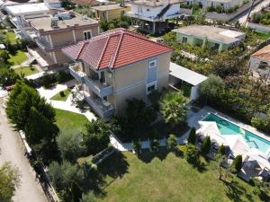 an aerial view of a house with a swimming pool at Villa Olive Tree in Fier