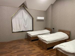 a hospital room with two beds and a window at Malibu hostel pub in Sheki +7 photos