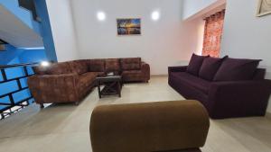 a living room with two couches and a table at Marvella 3BHK Luxury Villa with Shared Pool in Arpora