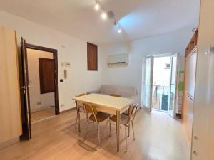 a room with a table and chairs and a couch at MiniMa - By Ligooria in Pietra Ligure