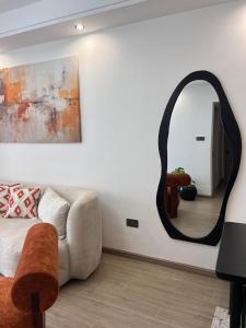 a living room with a couch and a mirror at Raydil Homes in Nairobi