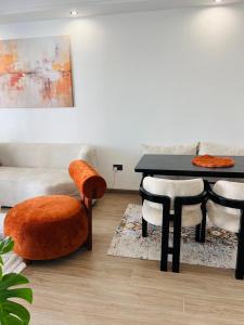a living room with a table and chairs and a couch at Raydil Homes in Nairobi