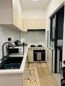 a kitchen with a sink and a stove at Raydil Homes in Nairobi