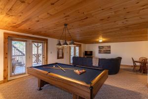 a living room with a pool table and a couch at Happy Trees Cabin in Laxon