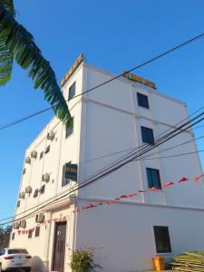 a white building with power lines in front of it at Khách Sạn Mỹ Hạnh in Uoc Le (1)