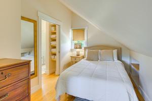 a bedroom with a white bed and a staircase at Romantic, Secluded Vermont Getaway with Hot Tub in Hancock