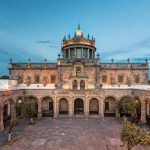 an old building with a tower on top of it at Centrally located apartment with AC, parking and pool in Guadalajara