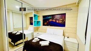 a small room with two beds and a mirror at Vg Fun by Diego Flats in Fortaleza +56 photos