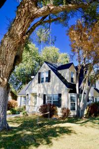 a white house with a tree in front of it at Film-featured sleeps 18 hot tub fire pit decks in Heber City