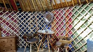 a small table and chairs in a yurt at Brambles Glamping in Bengeworth +45 photos