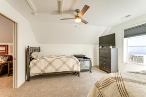 Un dormitorio con dos camas y un televisor y una ventana. en Sleek Getaway on Lake Wawasee with Private Dock!, en North Webster