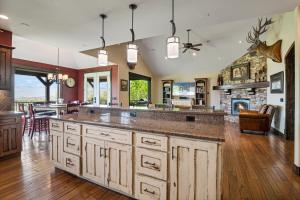 Una cocina con una gran isla central con chimenea. en Sage haven lux lodge sleeps 24 firepit 7br5.5ba, en Center Creek