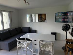 a living room with a couch and a table and chairs at Panorama Lakeside Retreat Seelisberg in Seelisberg +9 photos
