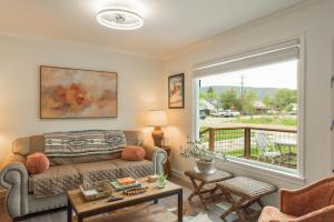 a living room with a couch and a balcony at Heber base camp sleeps 7 fire pit pets ok AC in Parkview Trailer Court