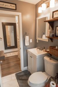 a bathroom with a toilet and a sink at Heber base camp sleeps 7 fire pit pets ok AC in Parkview Trailer Court +15 photos
