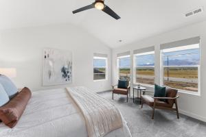 a bedroom with a bed and a ceiling fan at Nordic dream ski area views deck sleeps 10 in Parkview Trailer Court