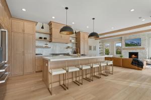 a kitchen with a large island with bar stools at Deer Valley views sleeps 16 hot tub deck gym in Parkview Trailer Court