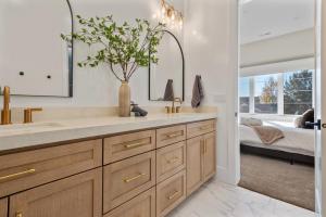 a bathroom with a sink and a mirror at Deer Valley views sleeps 16 hot tub deck gym in Parkview Trailer Court +56 photos