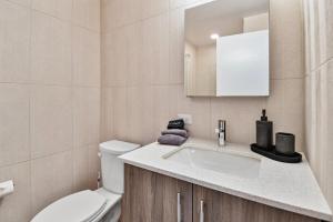 a bathroom with a white sink and a toilet at Lux Sleeps 4 king bed hot tub views gym in Cranmer +35 photos