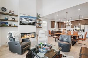 a living room with a fireplace and a dining room at Ski area close 5br 5.5ba resort views sleeps 15 in Silver Creek Junction