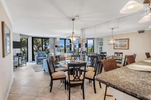 a dining room and living room with a table and chairs at SW122D: 122D Shipwatch in Isle of Palms