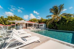 an image of a swimming pool at a villa at La Baie Du Pélican 3 rooms in Mare Gaillard
