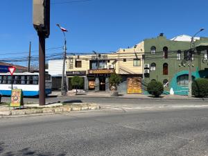 a city street with a bus on the street at Alojamiento Talca centro in Talca