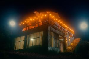 a house with lights on top of it at night at Glamping Utopie - Bogota in Subía