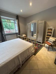 a bedroom with a bed and a mirror and a chair at Aperegina in Castellinaldo