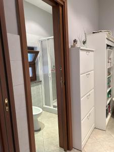 a bathroom with a white dresser and a toilet at Aperegina in Castellinaldo +17 photos