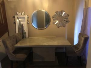 a table with chairs and a mirror on a wall at Very Quite and Comfortable Place in Clayton