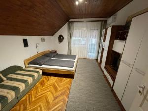 a bedroom with two beds and a television at Balaton-Lak Apartmanház in Siófok