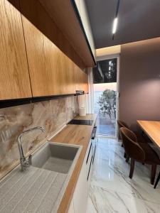 a kitchen with a sink and a counter top at Sunset Luxury Apartment Shengjin in Lezhë +22 photos